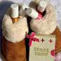 Best lip care products displayed in fur-lined boots with a cute packaging design on a snowy surface