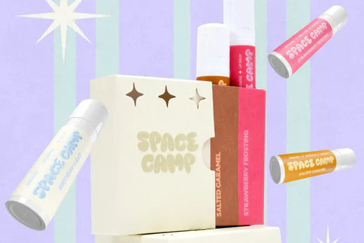 Space Camp flavored lip balm set featuring flavors like Salted Caramel and Strawberry Frosting with retro-inspired packaging