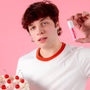Person holding a lip balm tube and cherry cake, illustrating how to choose lip balm.