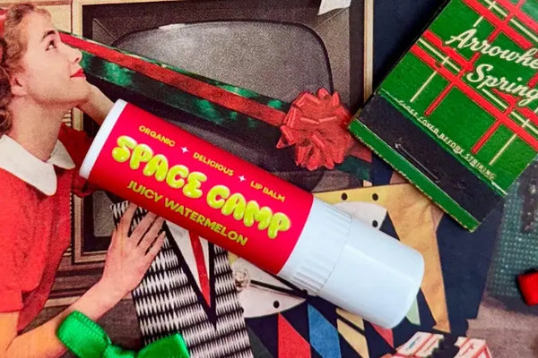 Flavored lip balm in juicy watermelon, placed on a festive vintage magazine background