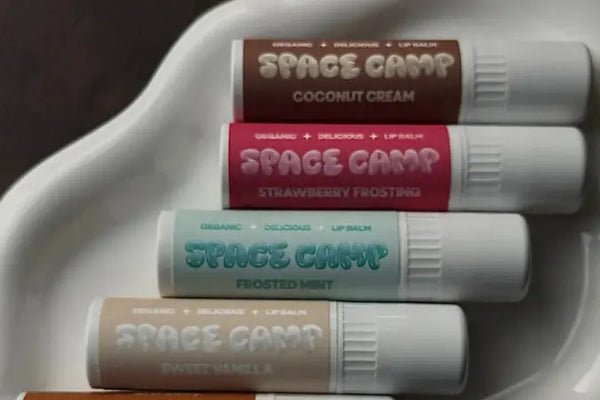 Watermelon lip balm being applied by woman using Space Camp juicy watermelon for soft hydration.