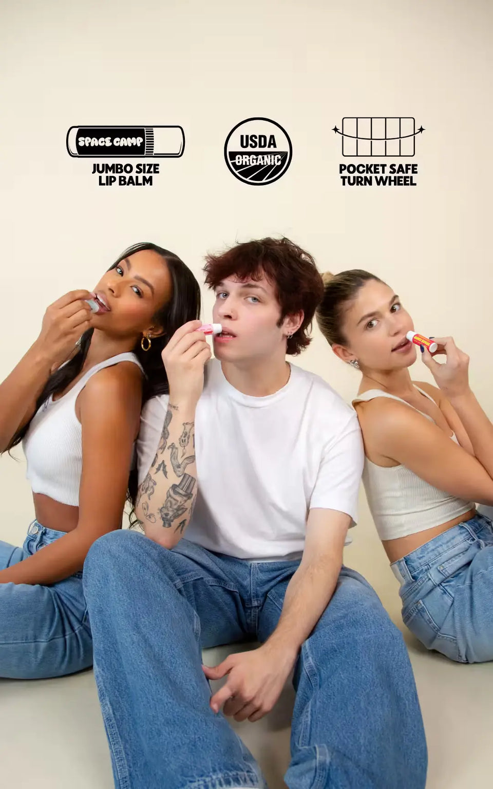  Three young adults in casual outfits applying jumbo-sized lip balm, highlighted by organic and product features icons above