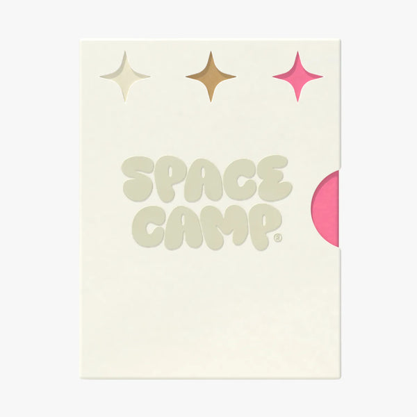 A Space Camp branded card with sparkle graphics and a pink lip balm tube peeking from behind.
