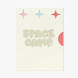A Space Camp branded card with sparkle graphics and a red lip balm tube peeking from behind.