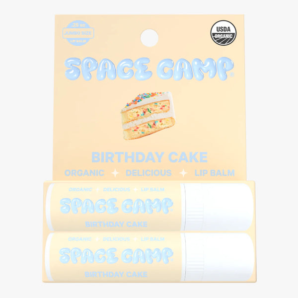 Space Camp Birthday Cake lip balm jumbo size packaging with two tubes and a slice of cake illustration.