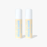 Two Space Camp Birthday Cake lip balm tubes with light yellow labels and white caps standing side by side on a white background.