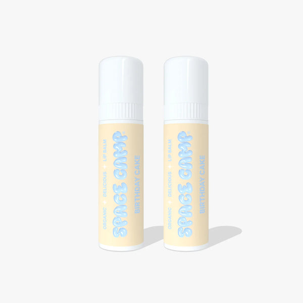 Two Space Camp Birthday Cake lip balm tubes with light yellow labels and white caps standing side by side on a white background.