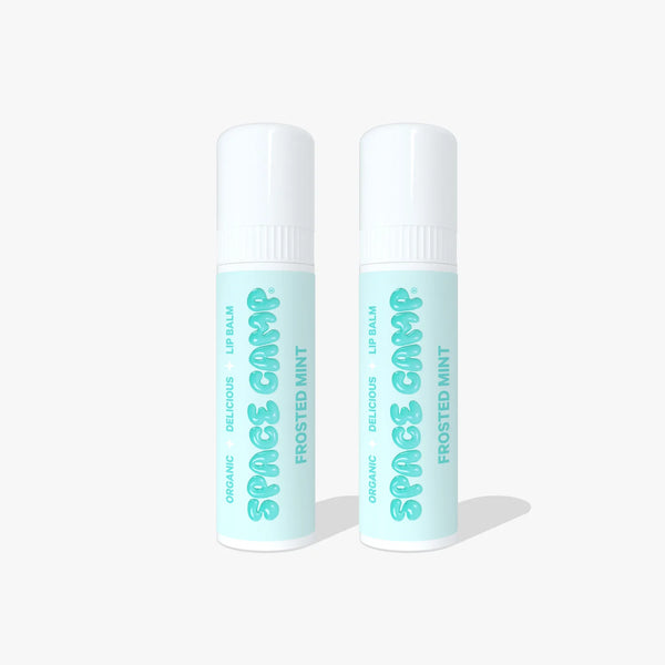 Two Space Camp Frosted Mint organic lip balm tubes with mint green labels and white caps on a light blue background.