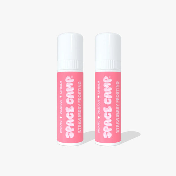 Two Space Camp Strawberry Frosting lip balm tubes with pink labels standing side by side on a white background.